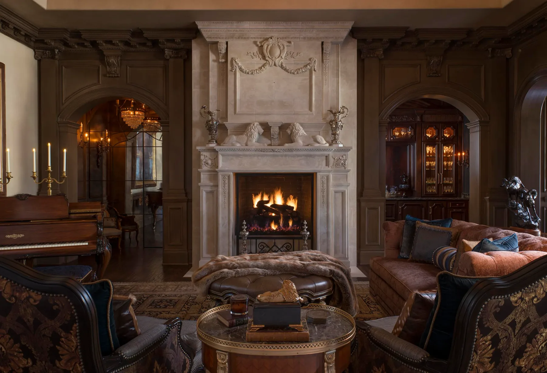 MEG interior with a carved fireplace, piano, and classic furniture